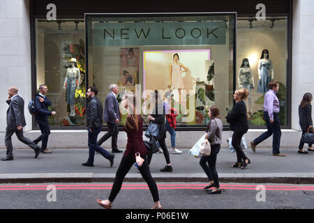 Office workers, tourists and pedestrians walk past branches of New Look on the junction of Gracechurch and Lombard Street in the City of London. The h Stock Photo