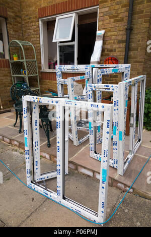 a Buy to let property / maisonette house having new replacement uPVC  / u PVC windows fitted / installed and old wooden window removed. UK (99) Stock Photo
