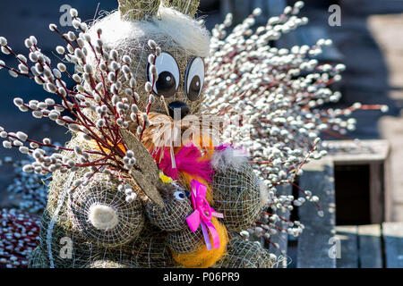 Straw-shaped bunny shapes with willow branches twings. Easter decorations. Easter holidays. Stock Photo