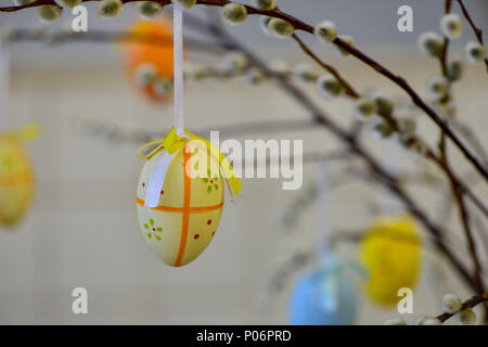 Easter eggs hanging from the willow branches. Easter decorations. Easter holidays. Stock Photo