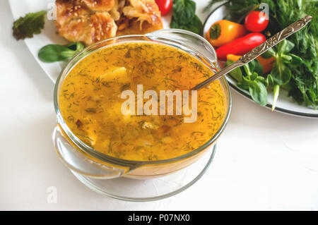 Soup with dumplings and meat on a wooden table, a portion of Bavarian soup griesnockerl, selective focus. Close up. Stock Photo