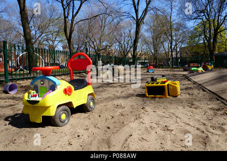 Playground in public park with a lot of colorful public toys abandonned by children. Stock Photo