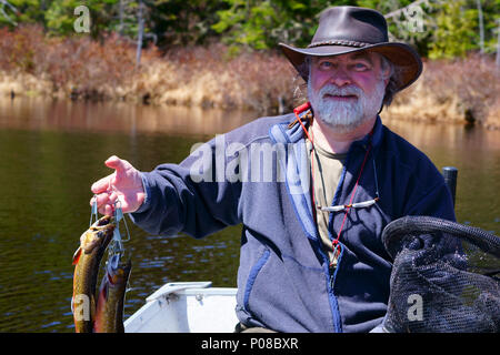 Caucasian male fishing in a pond surrounded by tall green water