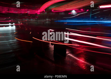 Abstract tail lights at street at night time with people Stock Photo