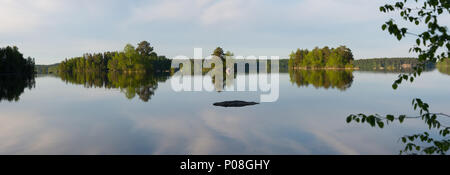 Cloud reflections panorama. Lake Kukkia, Luopioinen, Finland.