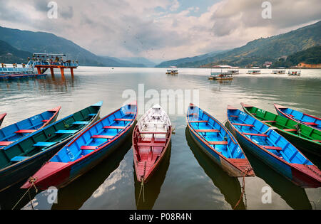 Color boats at Phewa lake shore in Pokhara, Nepal. Stock Photo