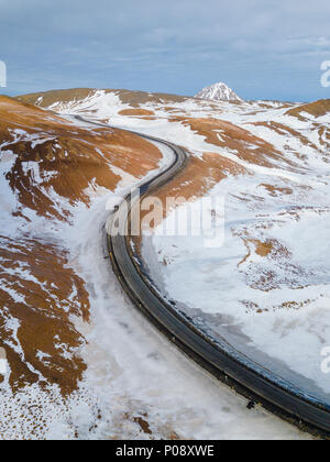 Aerial view of a winding mountain road through the Pyrenees forest with ...