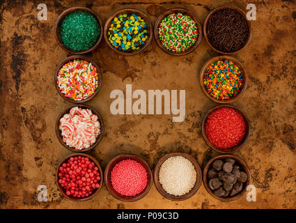Frame of Sprinkles in Bowls over cookie sheet Stock Photo