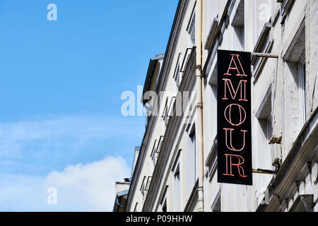 the vertical red neon sign of Hôtel Amour located in the 9th arrondissement (Pigalle) of Paris, France Stock Photo