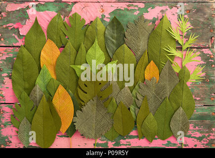 Handmade paper flower leaves on an old wooden table Stock Photo