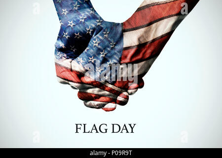 closeup of two people holding hands, patterned as the flag of the United States, and the text flag on an off-white background Stock Photo