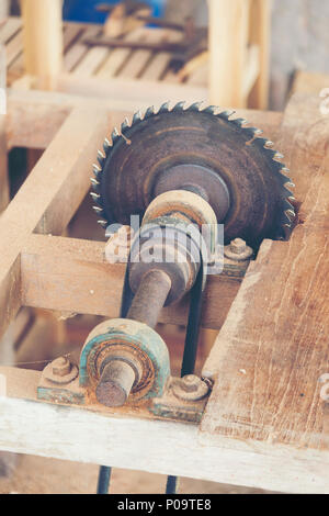 Carpenter cutting flaxboard using sliding compound mitre saw Stock Photo