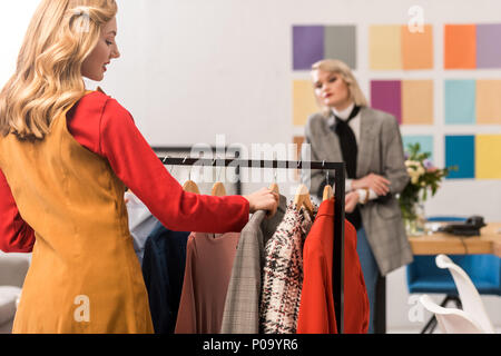 fashion designers working with clothes in modern office Stock Photo