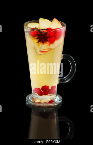Cup of apple tea with cranberry and cinnamon isolated on black Stock Photo