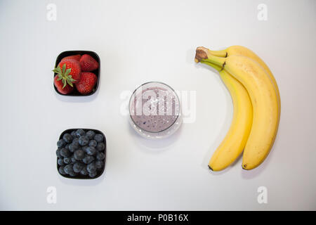 Fruit smoothie in a clear glass made from blueberry, banana and strawberry. Stock Photo