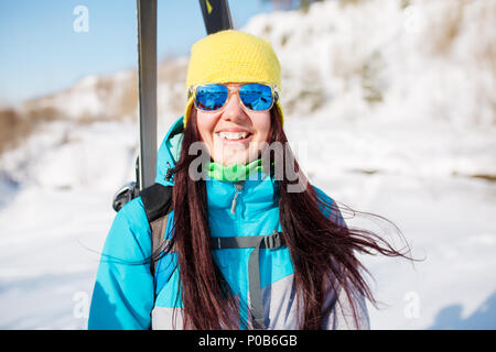 Portrait of sports girl with skis and sticks in winter Stock Photo