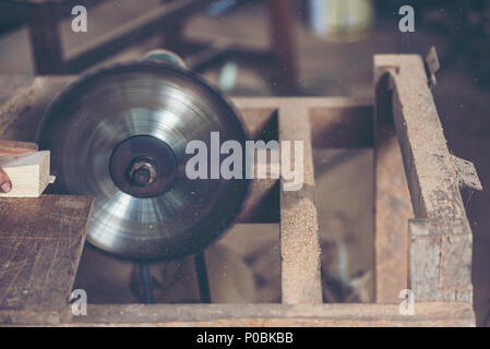 Background image of woodworking workshop: carpenters work table with different tools and wood cutting stand, vintage filter image Stock Photo