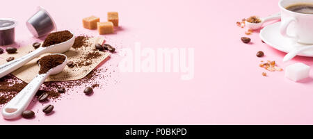 Food background with ground coffee in white spoons, coffee beans and capsules, sugar. Copy space, banner. Stock Photo