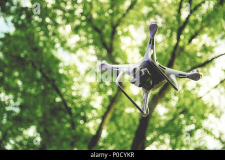 Drone with camera on green nature background Stock Photo