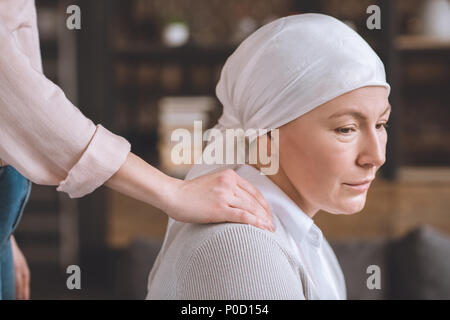 cropped shot of woman supporting sick upset mature mother in kerchief Stock Photo