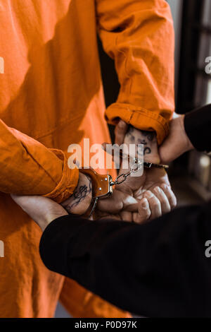 Young police officer holding handcuffs Stock Photo - Alamy