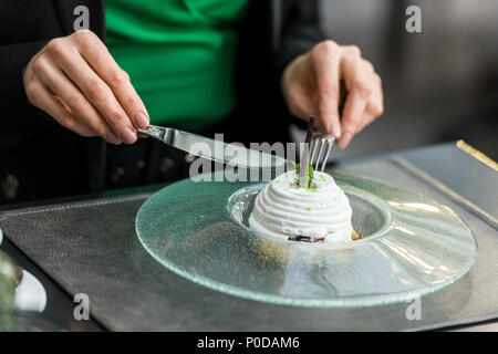 partial view of woman eating dessert in restaurant Stock Photo