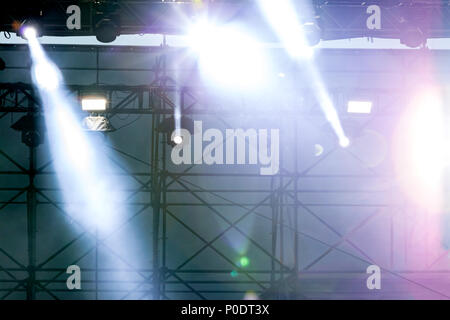 bright rays of professional stage spotlights during outdoor concert Stock Photo