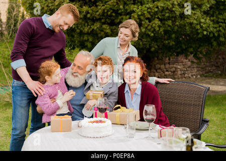 big happy family celebrating grandfathers birthday together at countryside Stock Photo