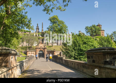 people walking over the Bridge of Sighs entering Glasgow Necropolis, victorian cemetery, Glasgow, Scotland, UK Stock Photo