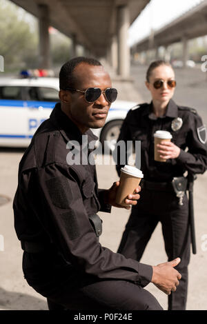 serious young police officers having coffee break Stock Photo