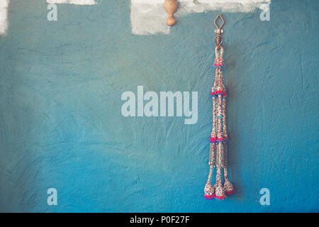 Blue wall background with knitting yarn Stock Photo