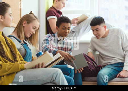 Group of multicultural high school teenage high school students doing homework during school break Stock Photo