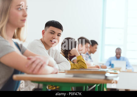 Portrait of high school teenage asian student with classmates and teacher sitting in classroom Stock Photo