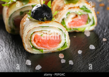 Pancake with salmon and salad leves roll Stock Photo