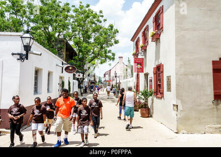 Florida Saint St. Augustine,St. George Street,stores,shopping district,Black man men male,boy boys,kid kids child children youngster,girl girls,female Stock Photo