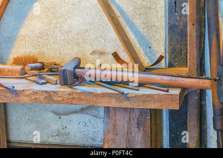 View into an old workshop with different tools on a wooden board Stock Photo
