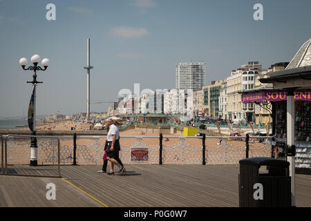 People walking along Brighton Palace Pier, Brighton, East Sussex, England, UK Stock Photo