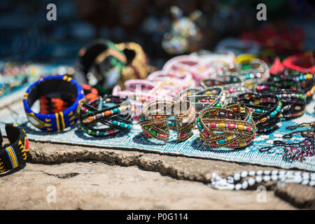 Colorful Beadwork on a cracked stone surface shallow depth of field Stock Photo