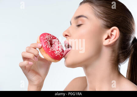 Pretty woman holding unhealthy glazed donut  on a white background Stock Photo