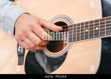 Cropped shot of man playing acoustic guitar Stock Photo