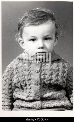 BRNO, THE CZECHOSLOVAK REPUBLIC, CIRCA 1972: A small boy retro photo.  Portrait photo was taken in photo studio. Early seventies.  Photo with dark tint, circa 1972. Stock Photo