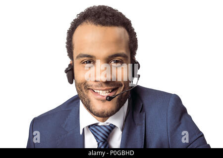 Smiling young african american call center operator in headset looking at camera Stock Photo