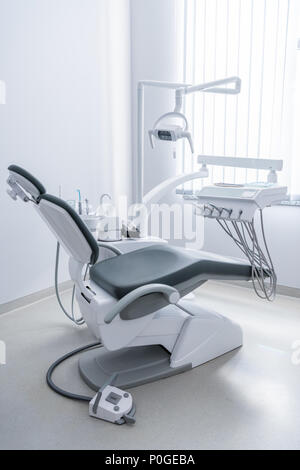 empty dentist office with chair and various dental equipment Stock Photo