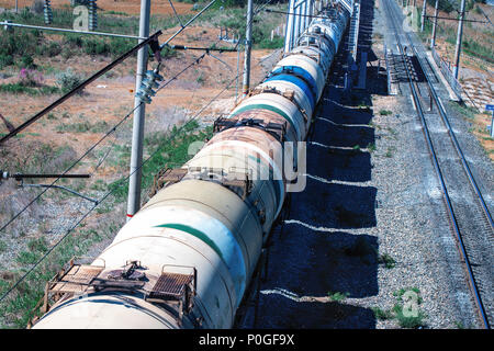 Train with oil tanks moving. Transportation of fuel on the railroad. Motion blur. Stock Photo