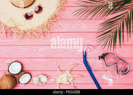 top view of different travel attributes on pink wooden surface Stock Photo