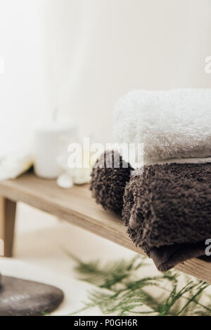 selective focus of arrangement of spa treatment accessories with towels on white background Stock Photo
