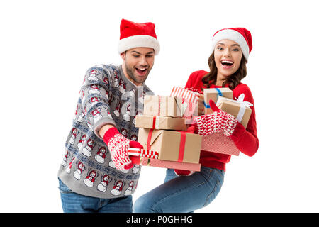 smiling young couple holding stacks of christmas gifts isolated on white Stock Photo