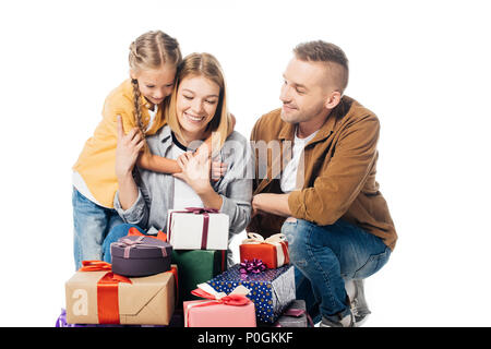 portrait of smiling family and pile of wrapped gifts isolated on white Stock Photo