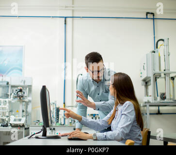 Young students presenting e-learning service in classroom Stock Photo