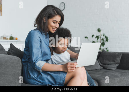 african american mother and son using laptop together at home Stock Photo